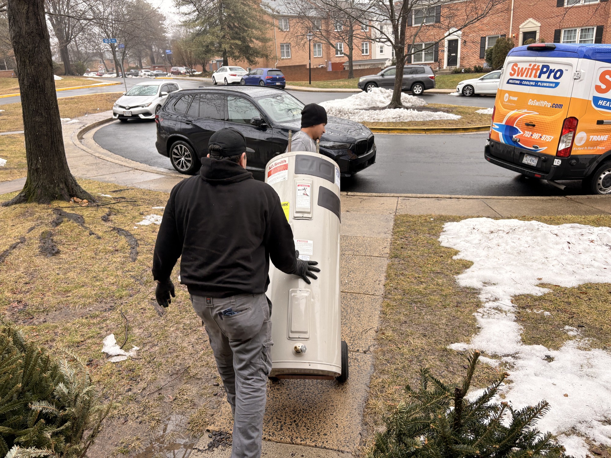 Moving the old tank with care.